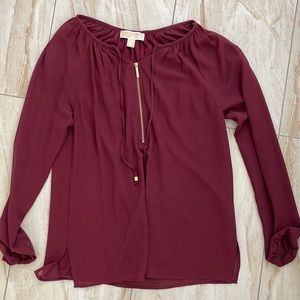 Burgundy flowy top with gold colored zipper